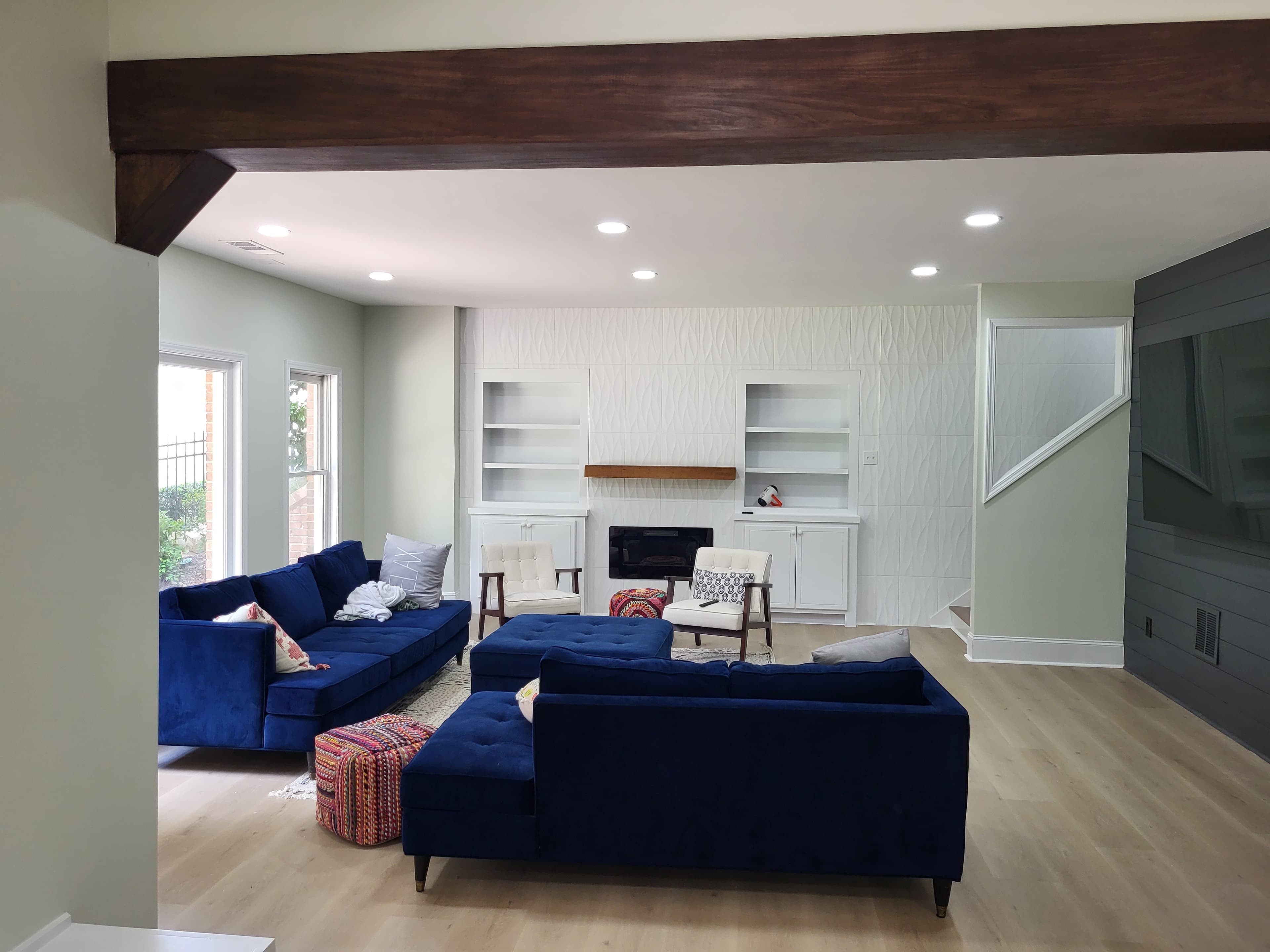 Sage green walls with sprayed white built-ins flanking the fireplace — after