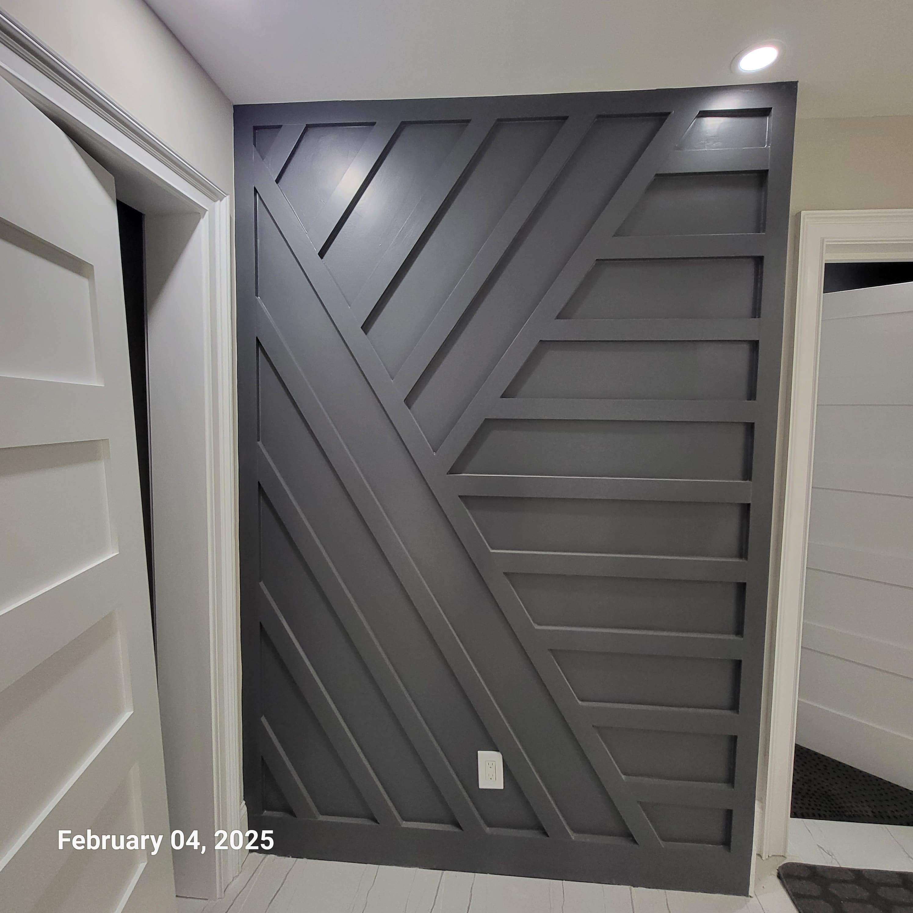 Custom built sun-ray geometric feature wall in deep grey, with crisp white shiplap above
